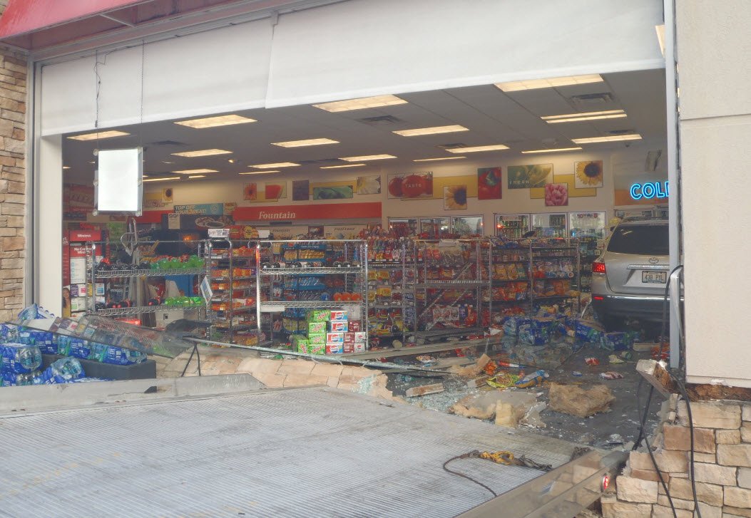 Two people were taken to a hospital when a vehicle crashed through a gas station in northern Kentucky Friday morning.