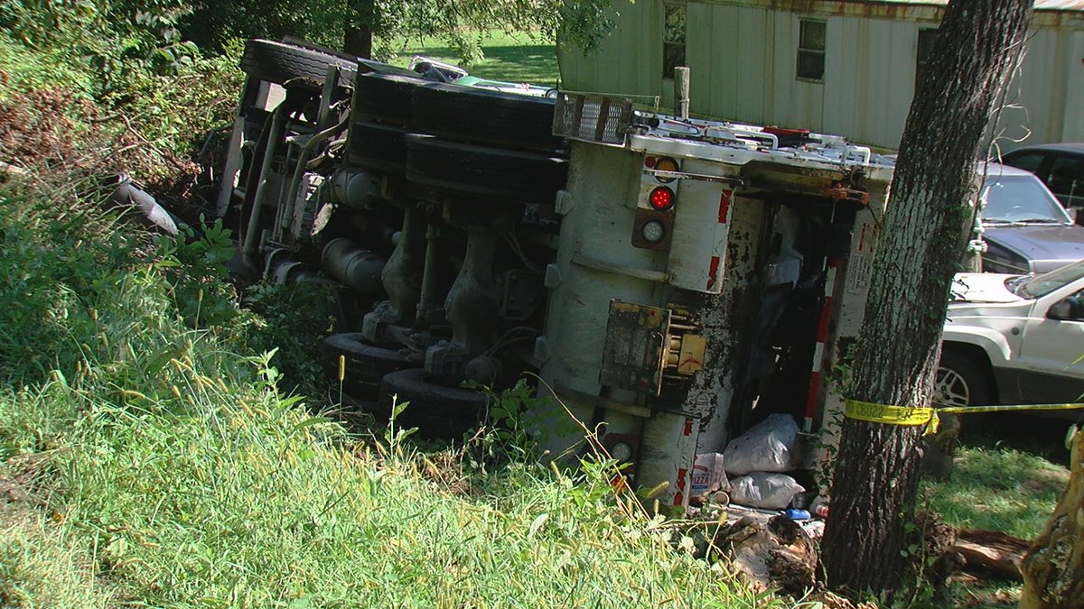 The driver of a garbage truck went off a rural road and tipped over in the yard of a home in Kenton County. The driver was on Steep Creek Road when the truck overturned before noon.