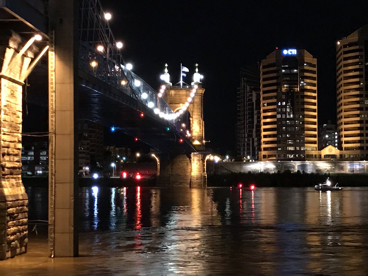Crews are working to rescue a person hanging from the under side of the Roebling Bridge 